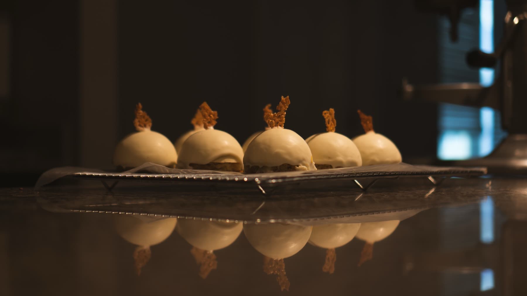 Dessert spheres reflected on the pass
