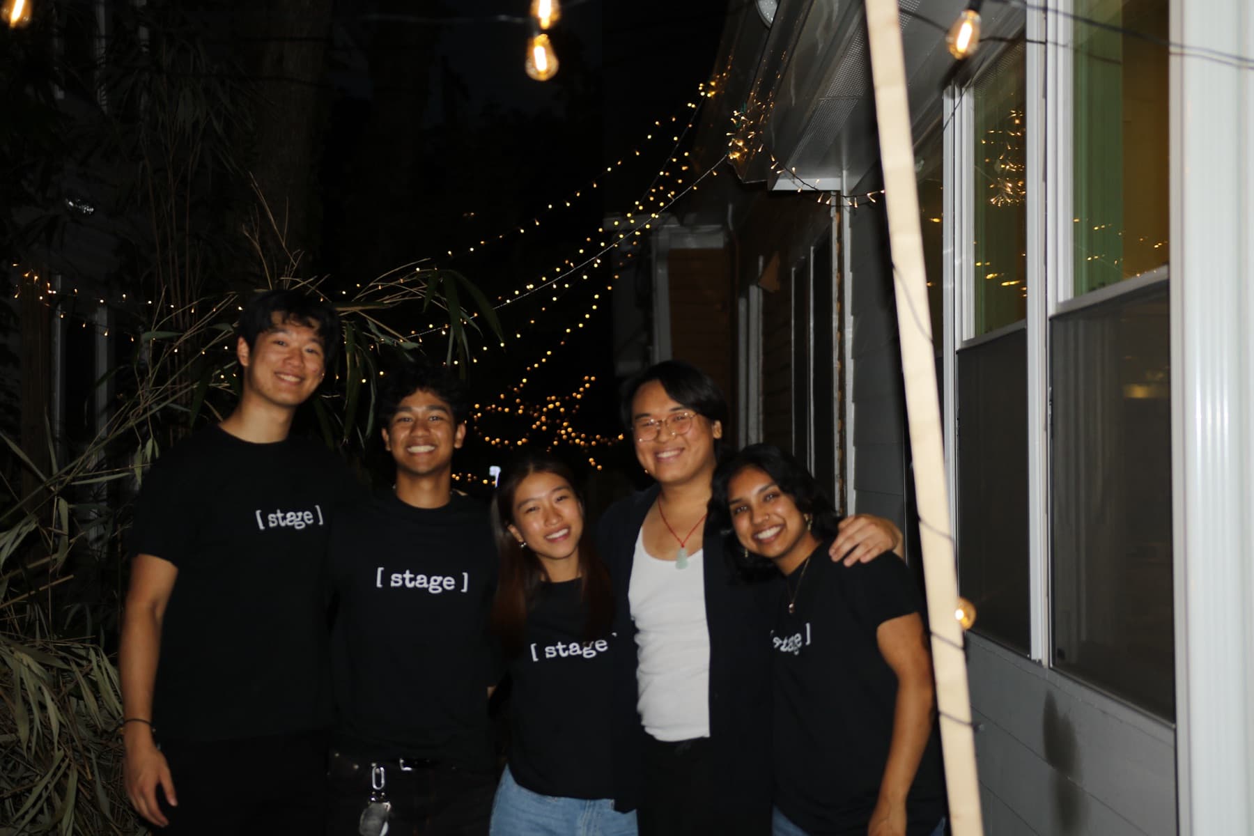 The team under string lights at the taco pop-up