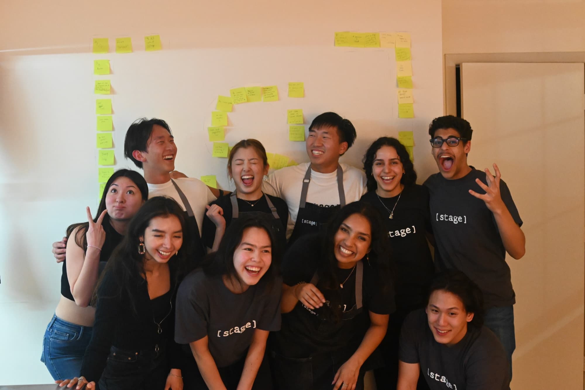 The [ stage ] team laughing together
